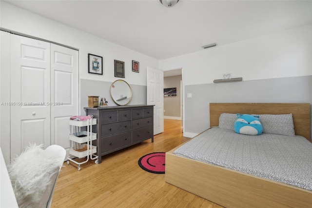 bedroom featuring wood-type flooring and a closet