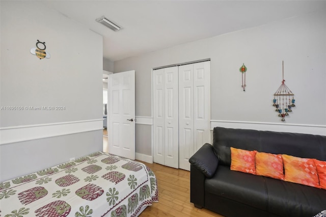 bedroom featuring wood-type flooring and a closet