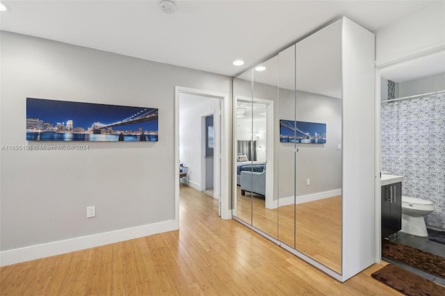 interior space featuring ensuite bath and hardwood / wood-style floors