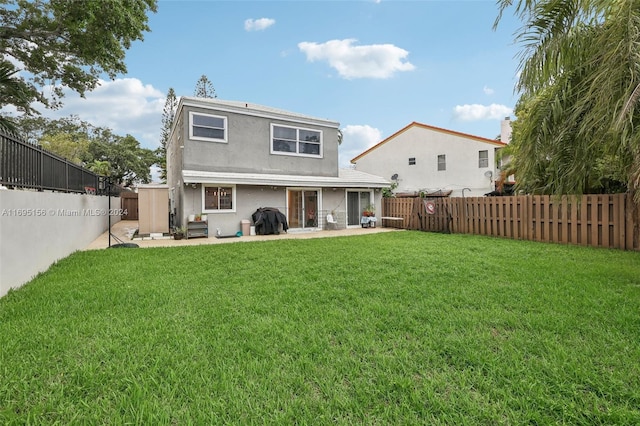 back of property featuring a lawn and a patio