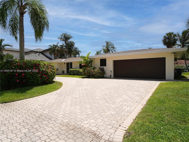 ranch-style house with a front yard and a garage