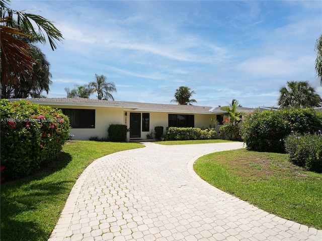 single story home featuring a front yard