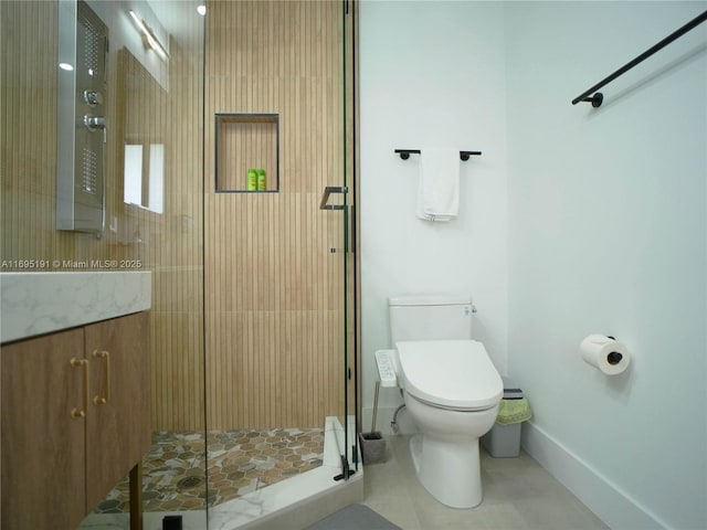 bathroom with tile patterned flooring, vanity, an enclosed shower, and toilet