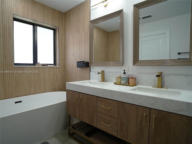 bathroom featuring vanity and a tub to relax in