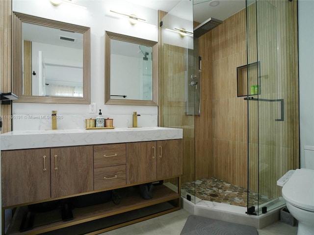 bathroom with an enclosed shower, vanity, and toilet