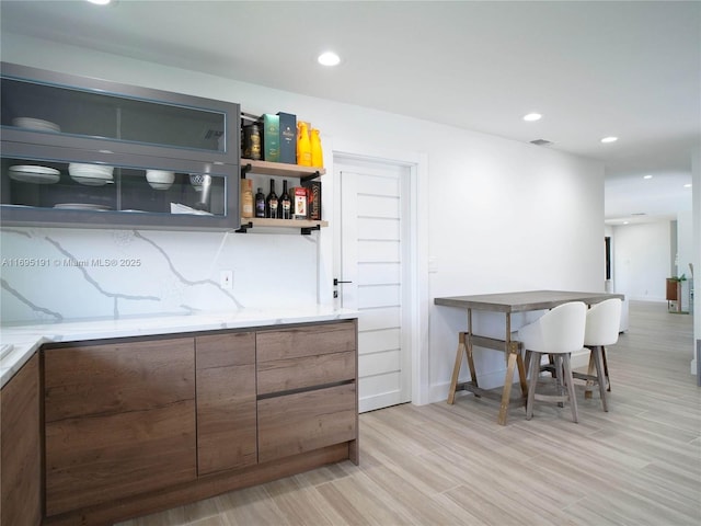 bar with light hardwood / wood-style floors