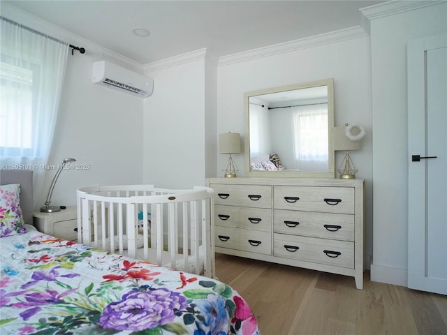 bedroom with crown molding, light hardwood / wood-style floors, and a wall mounted air conditioner