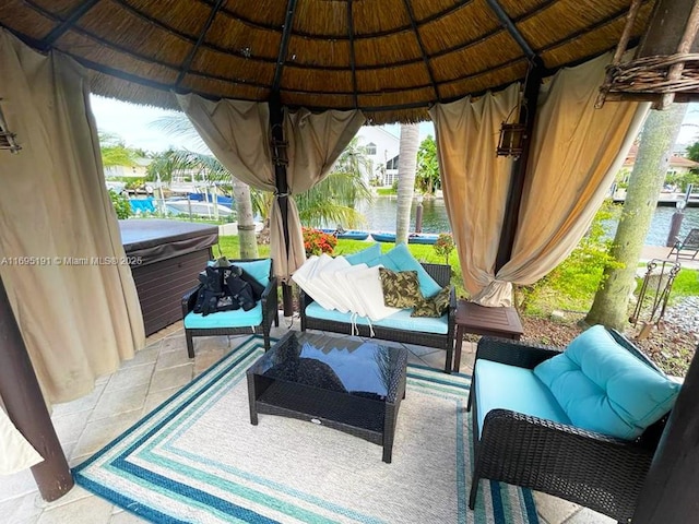 view of patio / terrace with a gazebo, outdoor lounge area, and a water view