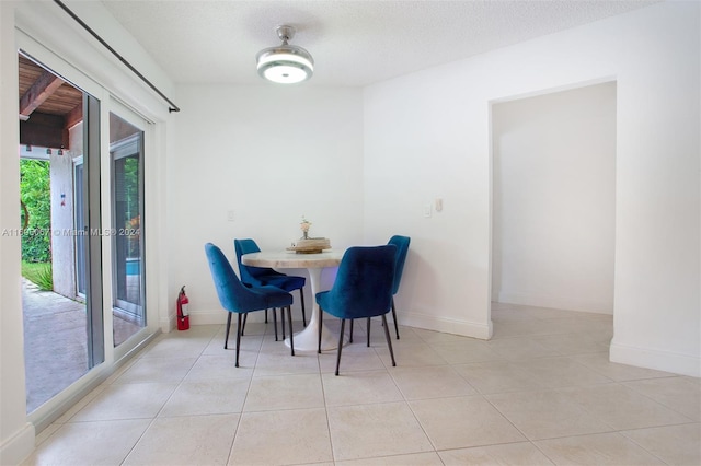 tiled dining room with a textured ceiling