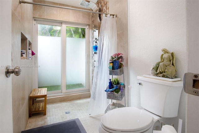 bathroom with toilet, tile patterned floors, and curtained shower