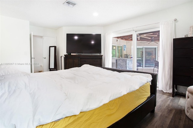 bedroom with dark wood-type flooring and a closet