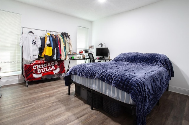 bedroom featuring wood-type flooring and multiple windows