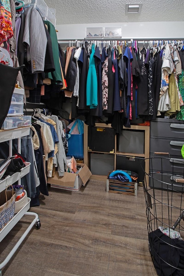 walk in closet with hardwood / wood-style floors