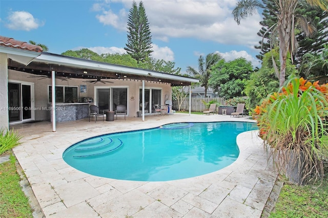 view of pool featuring ceiling fan and a patio area