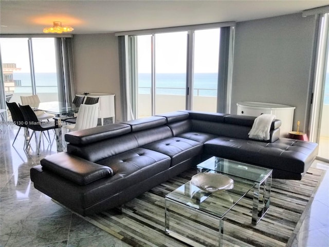 living room with a water view and a wall of windows