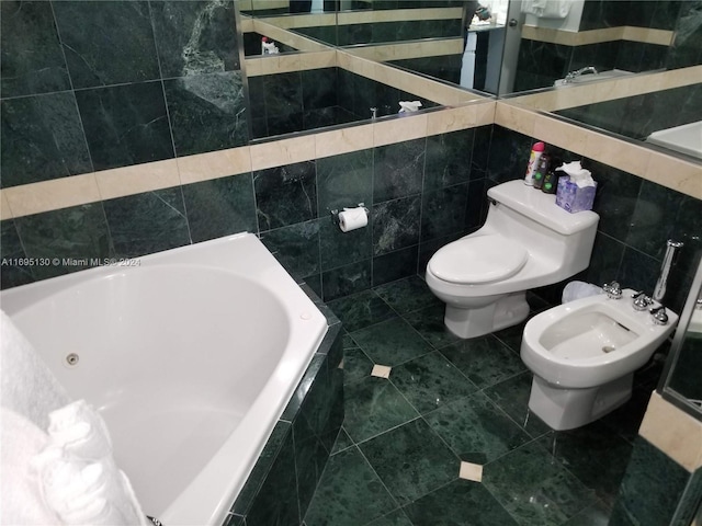 bathroom with a bidet, tile patterned flooring, toilet, tile walls, and tiled bath