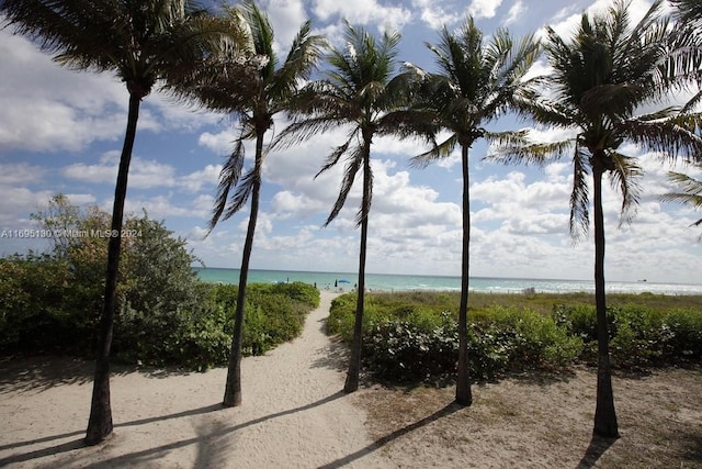 surrounding community with a beach view and a water view