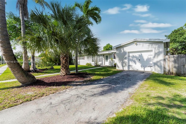 single story home with a garage and a front yard