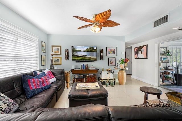 tiled living room featuring a wealth of natural light and ceiling fan