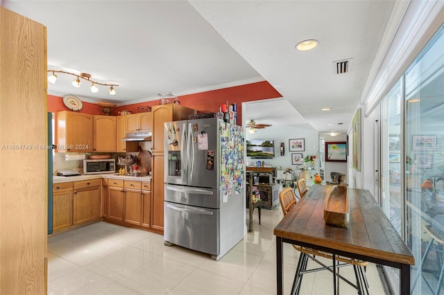 kitchen with ceiling fan, backsplash, appliances with stainless steel finishes, light tile patterned floors, and ornamental molding