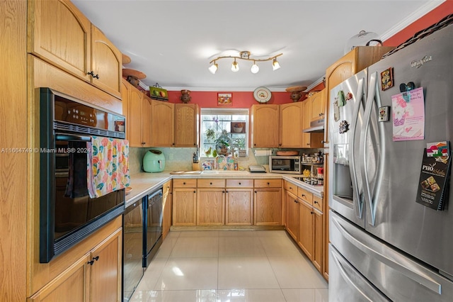 kitchen with light tile patterned floors, backsplash, ornamental molding, and black appliances