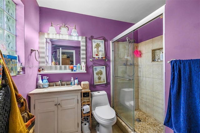 bathroom with vanity, toilet, and an enclosed shower