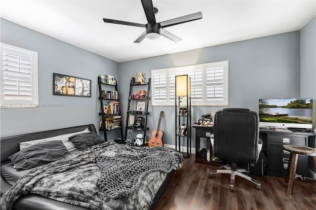 bedroom with ceiling fan and dark hardwood / wood-style flooring