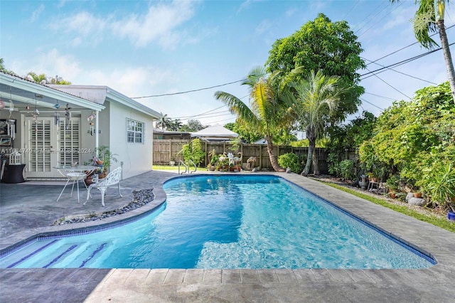 view of swimming pool with a patio area and french doors