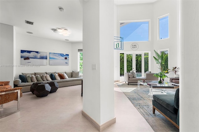 living room featuring a towering ceiling