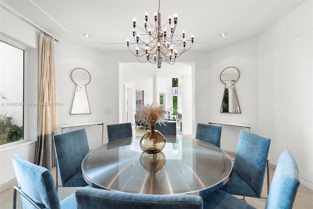 dining room featuring light wood-type flooring and a notable chandelier