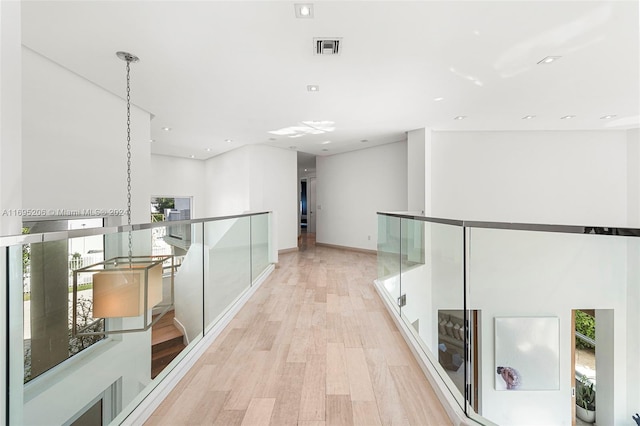 hall featuring light hardwood / wood-style flooring and plenty of natural light