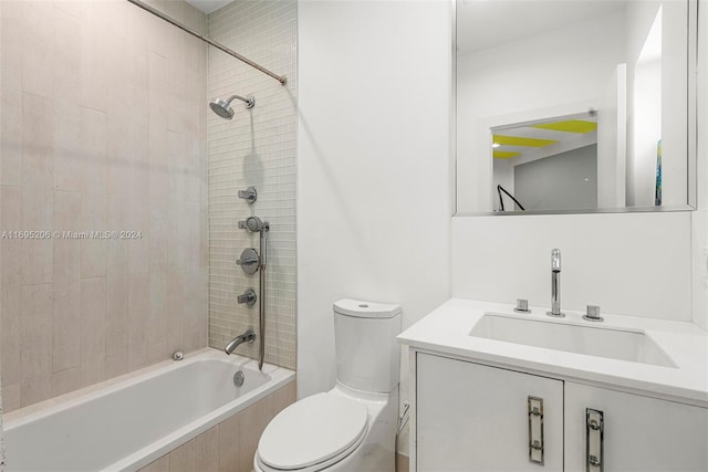 full bathroom featuring tiled shower / bath combo, toilet, and vanity