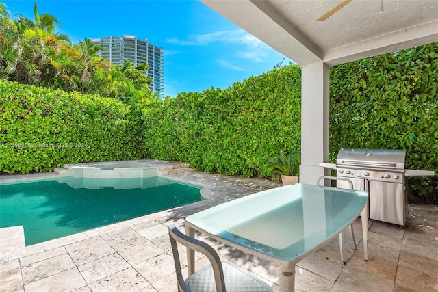 view of pool with an in ground hot tub, a patio, and grilling area