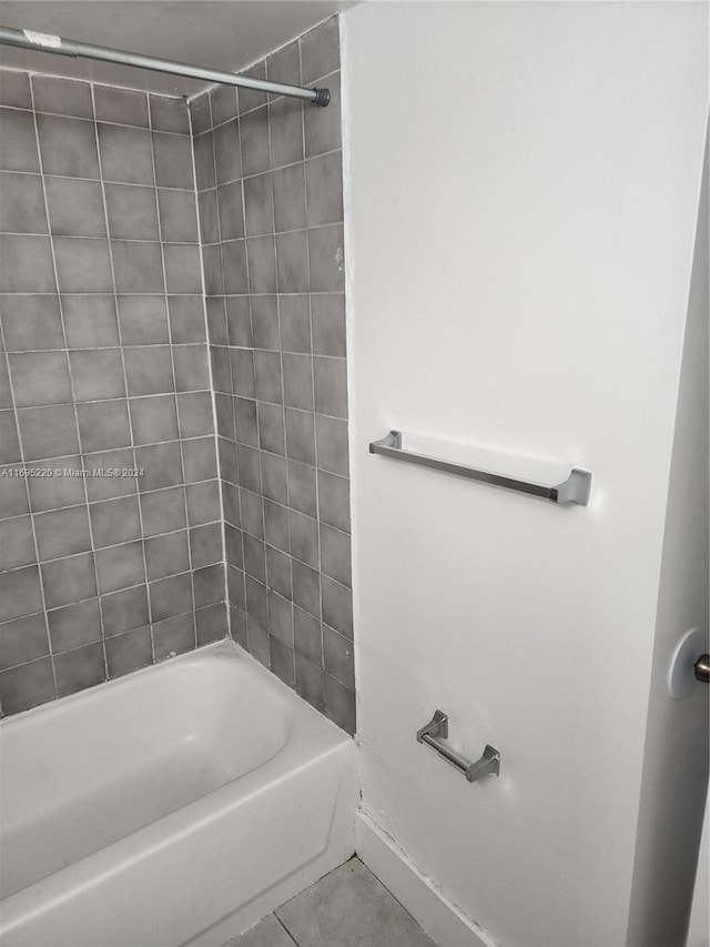 bathroom with tile patterned floors and tiled shower / bath combo