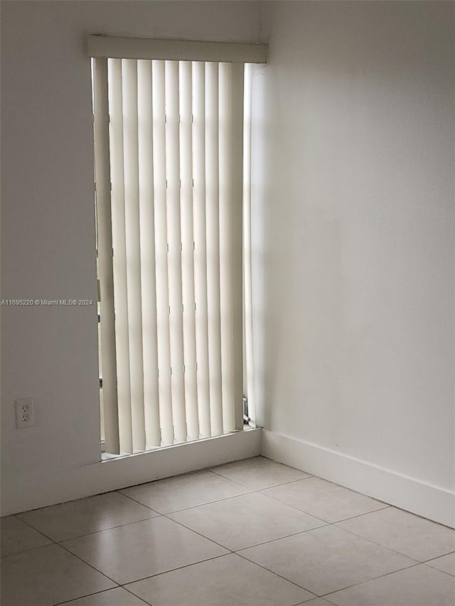 empty room with light tile patterned floors