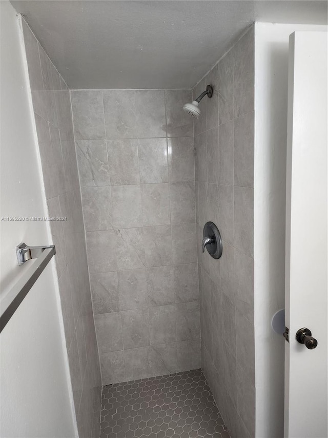 bathroom with a tile shower