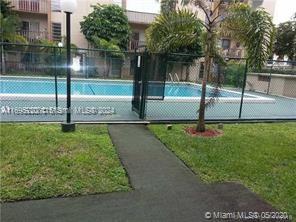 view of pool with a yard and tennis court