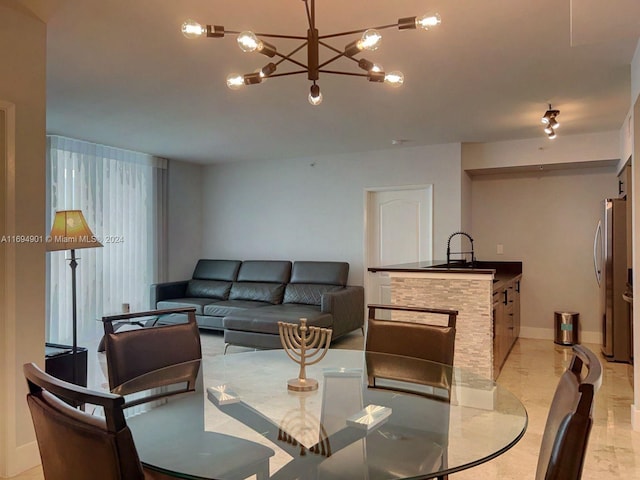 dining area featuring sink and a chandelier