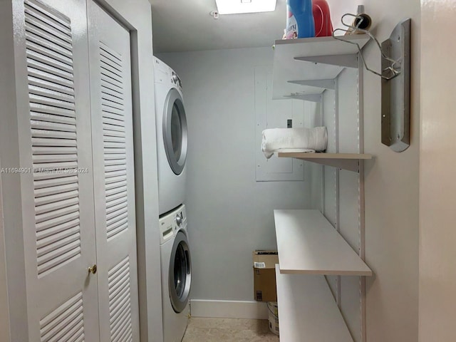 washroom featuring stacked washing maching and dryer