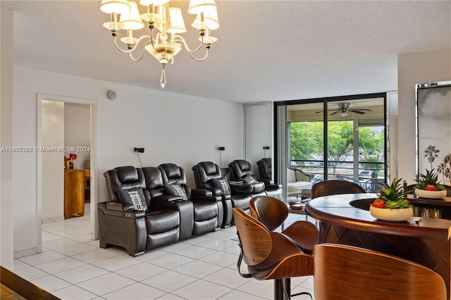 tiled cinema with ceiling fan with notable chandelier and a textured ceiling