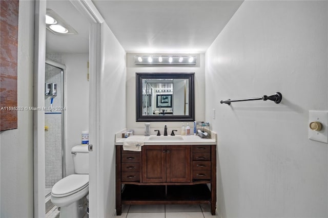 bathroom featuring tile patterned floors, walk in shower, vanity, and toilet