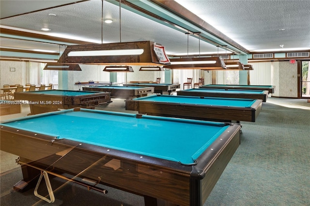 recreation room with a textured ceiling, carpet floors, and billiards