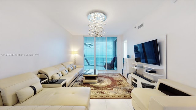 living room featuring light tile patterned floors and an inviting chandelier