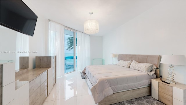 bedroom featuring light tile patterned flooring and access to exterior