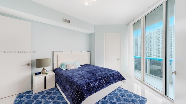 tiled bedroom with access to outside