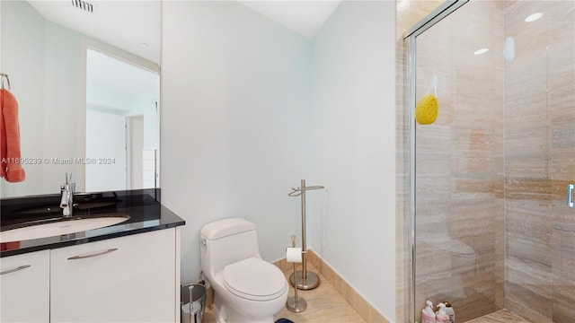 bathroom featuring tile patterned floors, walk in shower, vanity, and toilet