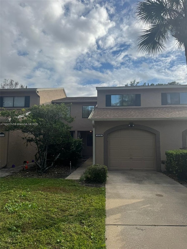 view of front of property with a garage and a front lawn