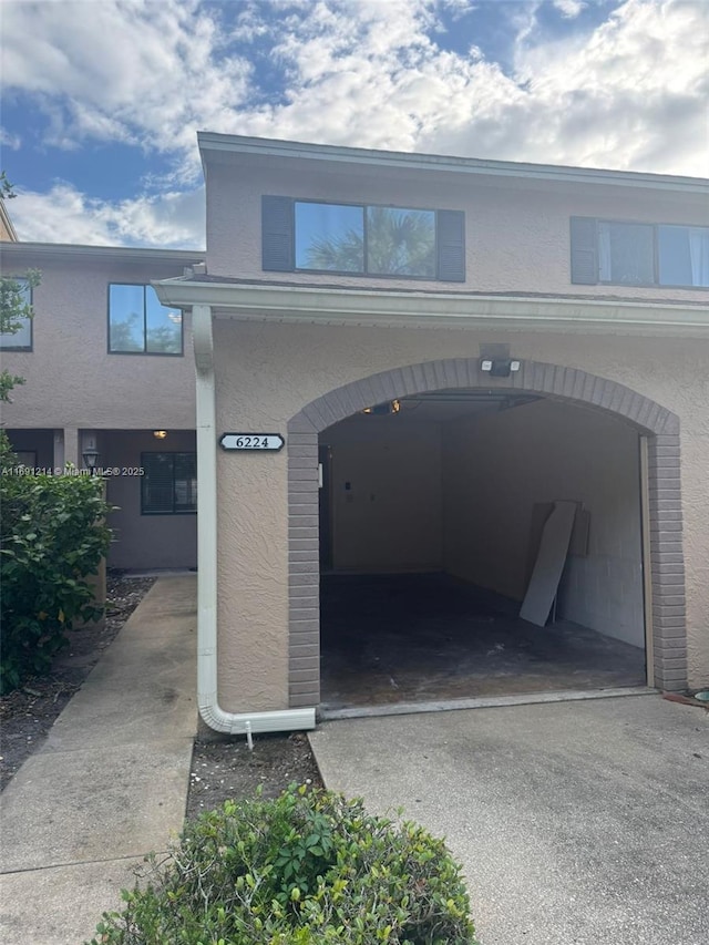 view of vehicle parking with a garage