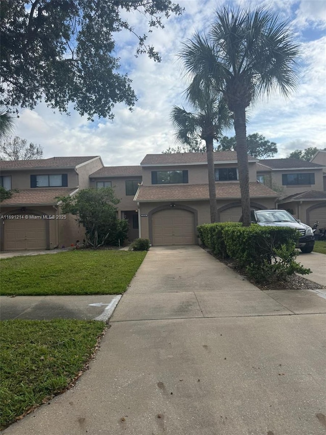 view of front of property featuring a garage and a front yard