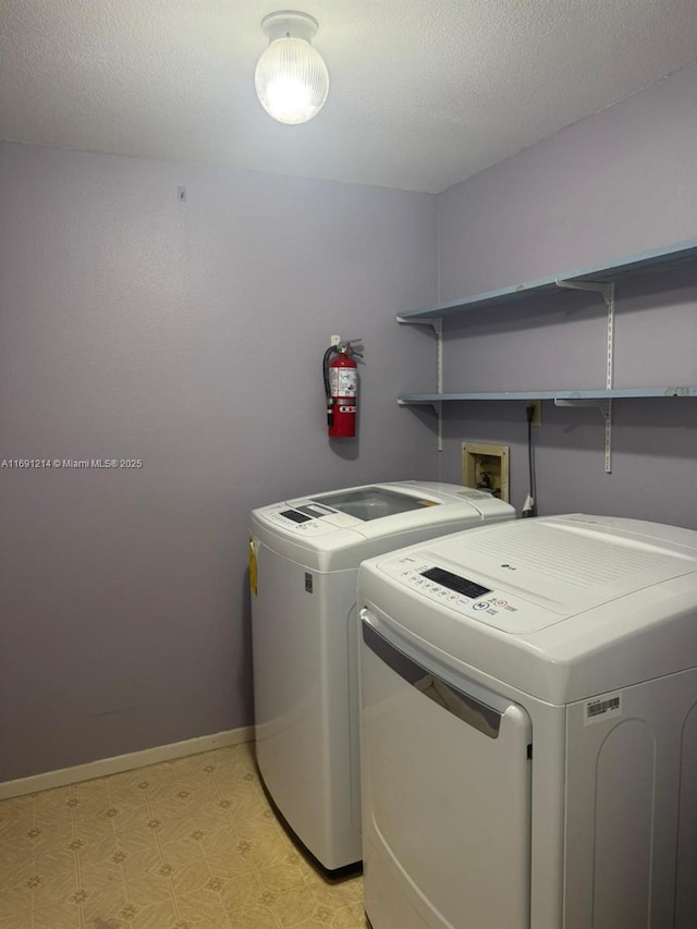 clothes washing area with independent washer and dryer